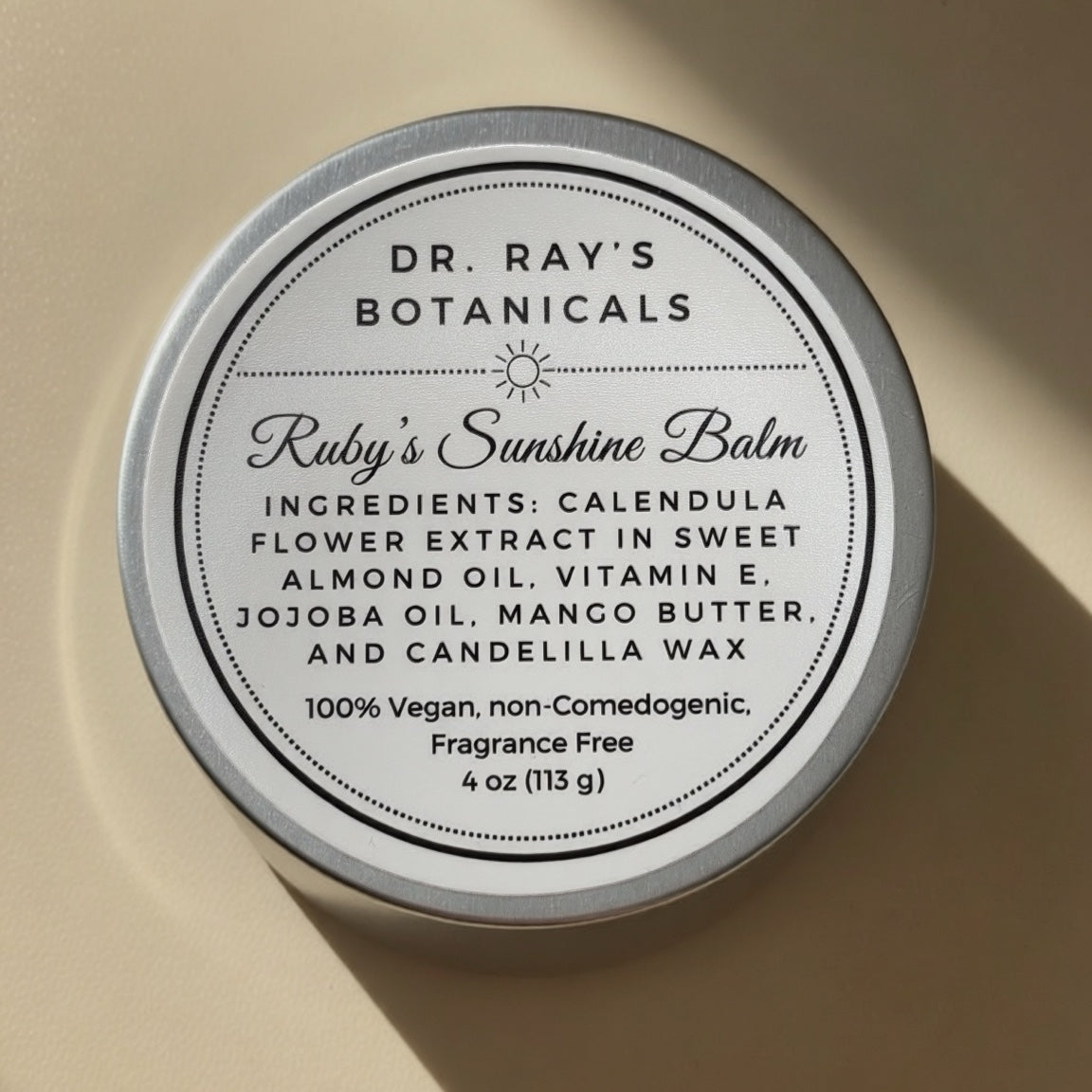 A round white tin of Calpurnia, a traditional Greek and Roman syrup, with a white label featuring black text and a small illustration of a woman holding a pitcher.